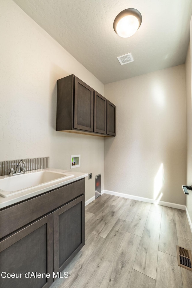 7587 E Duke Ln, Athol, ID 83801 - washroom featuring electric dryer hookup, visible vents, cabinet space, a sink, and hookup for a washing machine