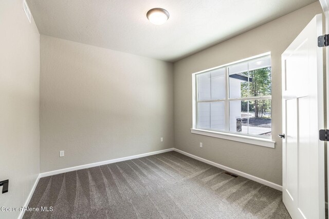 7587 E Duke Ln, Athol, ID 83801 - unfurnished room featuring baseboards, carpet flooring, and visible vents