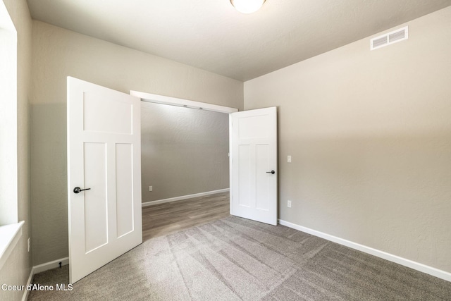 7587 E Duke Ln, Athol, ID 83801 - unfurnished bedroom featuring carpet floors, baseboards, a closet, and visible vents