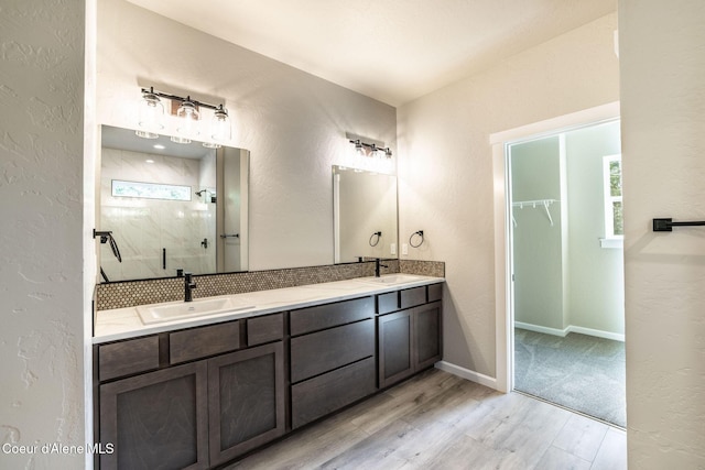 7587 E Duke Ln, Athol, ID 83801 - bathroom with a textured wall, a sink, double vanity, a shower stall, and wood finished floors