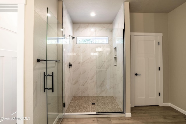 7587 E Duke Ln, Athol, ID 83801 - full bath featuring baseboards, a marble finish shower, and wood finished floors