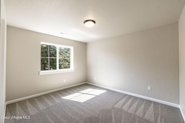 7587 E Duke Ln, Athol, ID 83801 - carpeted spare room featuring baseboards and a textured wall
