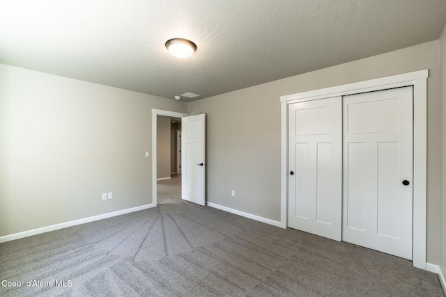 7587 E Duke Ln, Athol, ID 83801 - unfurnished bedroom featuring carpet floors, baseboards, and a closet