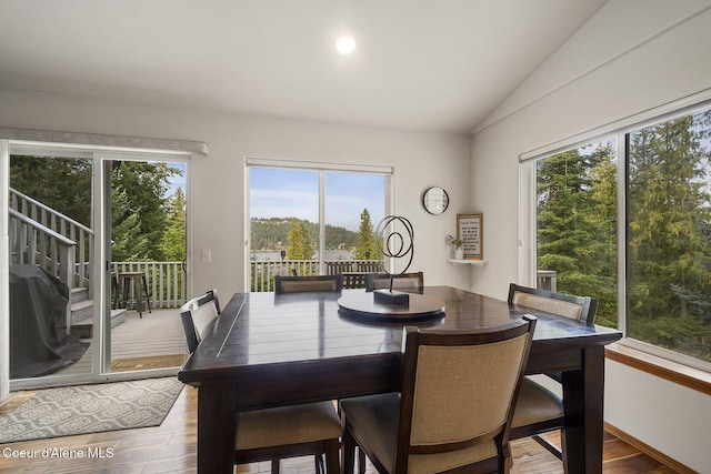 19820 S Alcan Rd, Coeur Dalene, ID 83814 - dining space with healthy amount of natural light, vaulted ceiling, and wood finished floors