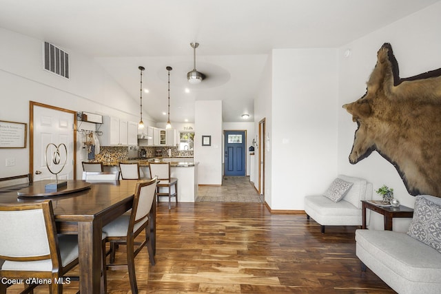 19820 S Alcan Rd, Coeur Dalene, ID 83814 - dining room with wood finished floors, high vaulted ceiling, and baseboards