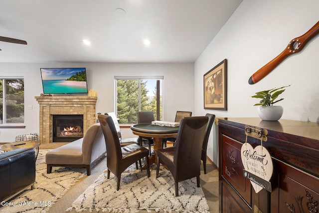 19820 S Alcan Rd, Coeur Dalene, ID 83814 - dining room featuring a fireplace, a ceiling fan, and recessed lighting