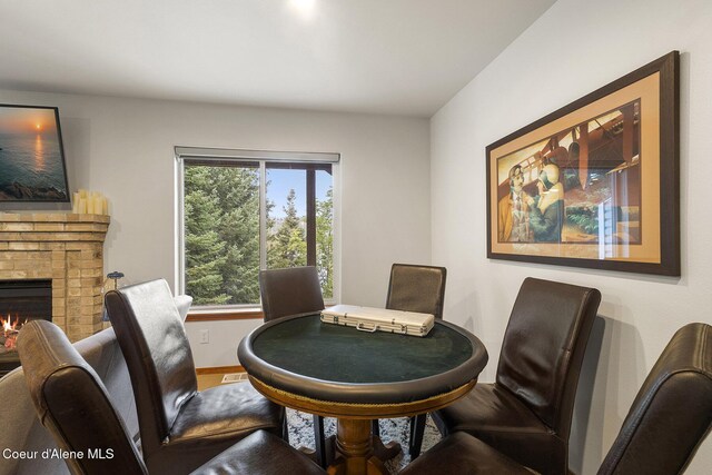19820 S Alcan Rd, Coeur Dalene, ID 83814 - dining room with a brick fireplace and baseboards