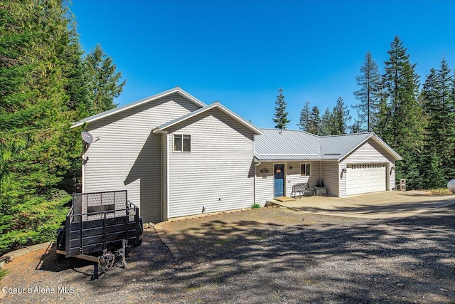 19820 S Alcan Rd, Coeur Dalene, ID 83814 - view of side of property with an attached garage, covered porch, and driveway