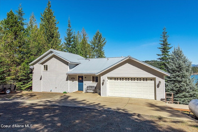 19820 S Alcan Rd, Coeur Dalene, ID 83814 - view of front of home with a garage, metal roof, and concrete driveway