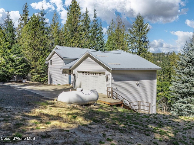 19820 S Alcan Rd, Coeur Dalene, ID 83814 - view of side of home with metal roof and an attached garage