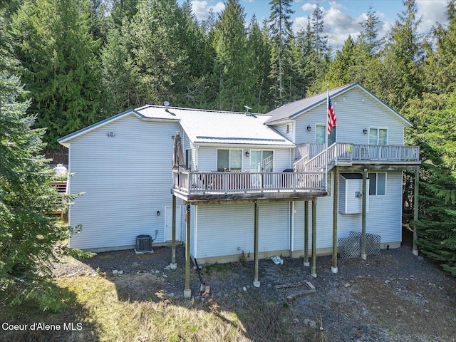19820 S Alcan Rd, Coeur Dalene, ID 83814 - back of house with a deck and a wooded view