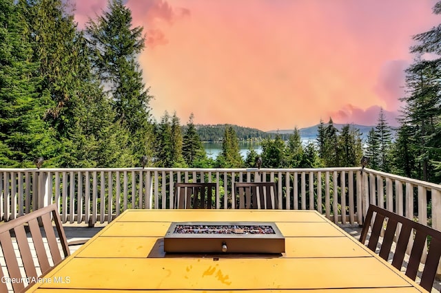 19820 S Alcan Rd, Coeur Dalene, ID 83814 - wooden deck featuring an outdoor fire pit, a mountain view, and grilling area