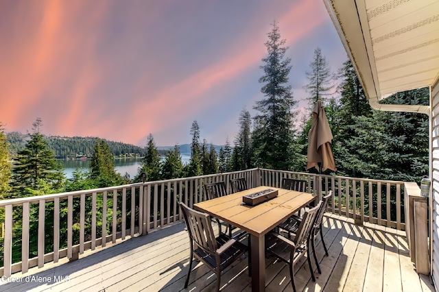 19820 S Alcan Rd, Coeur Dalene, ID 83814 - wooden deck featuring outdoor dining space, a water view, and view of scattered trees