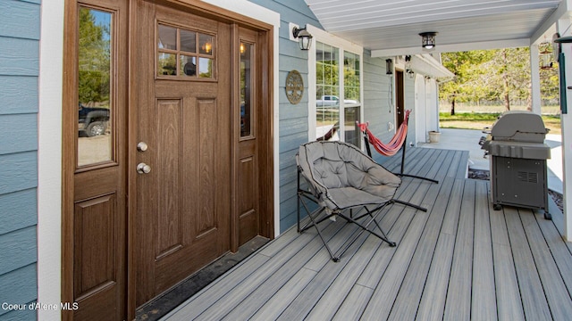 wooden deck featuring a porch and area for grilling
