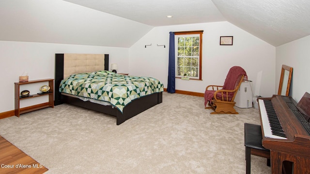 bedroom featuring baseboards, light carpet, and lofted ceiling