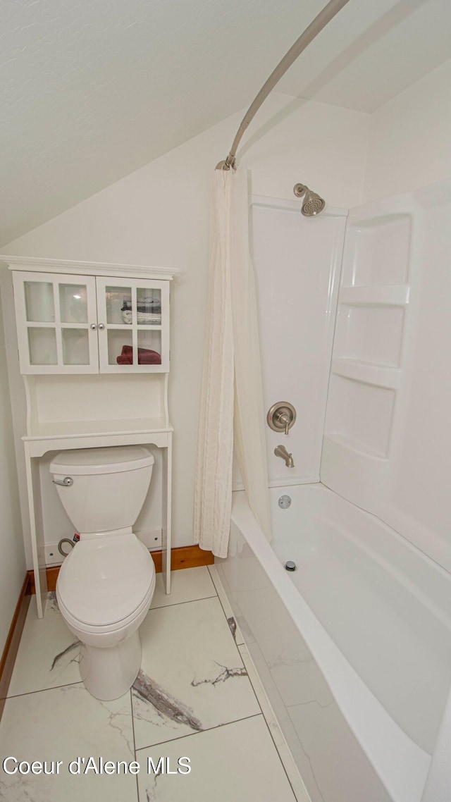 full bathroom featuring toilet, baseboards, shower / bath combination with curtain, and marble finish floor