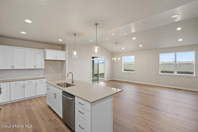 kitchen with decorative backsplash, recessed lighting, a sink, light wood finished floors, and dishwasher