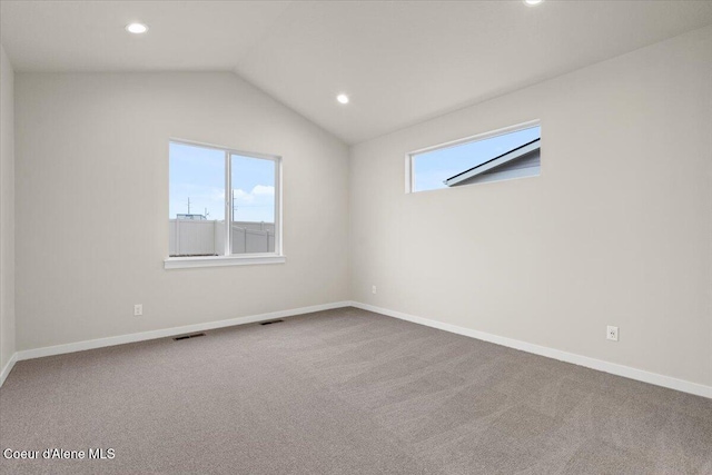 carpeted empty room featuring recessed lighting, baseboards, visible vents, and lofted ceiling