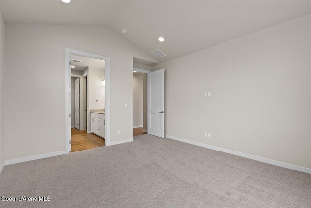 unfurnished bedroom with light carpet, recessed lighting, baseboards, lofted ceiling, and visible vents