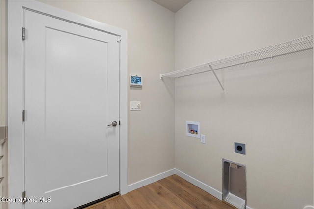 clothes washing area with laundry area, wood finished floors, baseboards, hookup for a washing machine, and electric dryer hookup