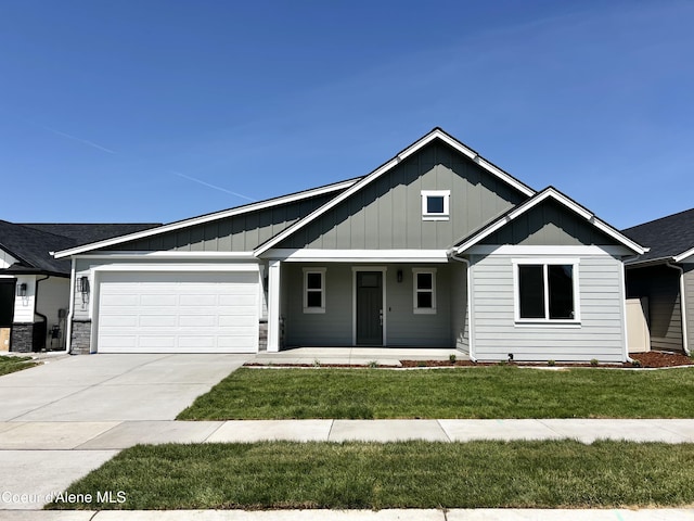 view of front of property featuring a garage, covered porch, board and batten siding, and a front yard