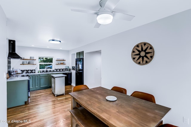 822 E Wallace Ave, Coeur Dalene, ID 83814 - kitchen featuring open shelves, green cabinets, black appliances, light wood-style floors, and extractor fan