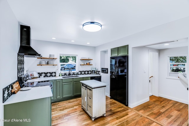 822 E Wallace Ave, Coeur Dalene, ID 83814 - kitchen featuring open shelves, range with electric stovetop, wall chimney exhaust hood, black fridge, and green cabinets