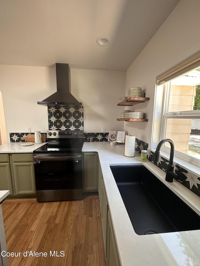 822 E Wallace Ave, Coeur Dalene, ID 83814 - kitchen with island range hood, stainless steel electric range, a sink, light countertops, and light wood-style flooring