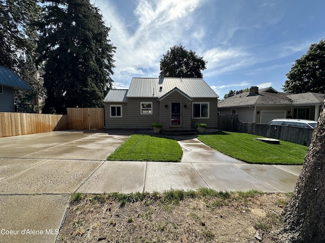 822 E Wallace Ave, Coeur Dalene, ID 83814 - view of front of house with concrete driveway, a front lawn, fence, and metal roof