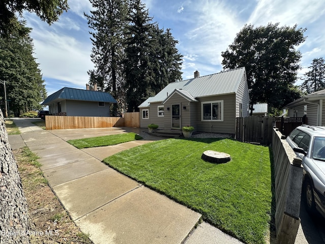 822 E Wallace Ave, Coeur Dalene, ID 83814 - view of front of home with fence, metal roof, and a front lawn