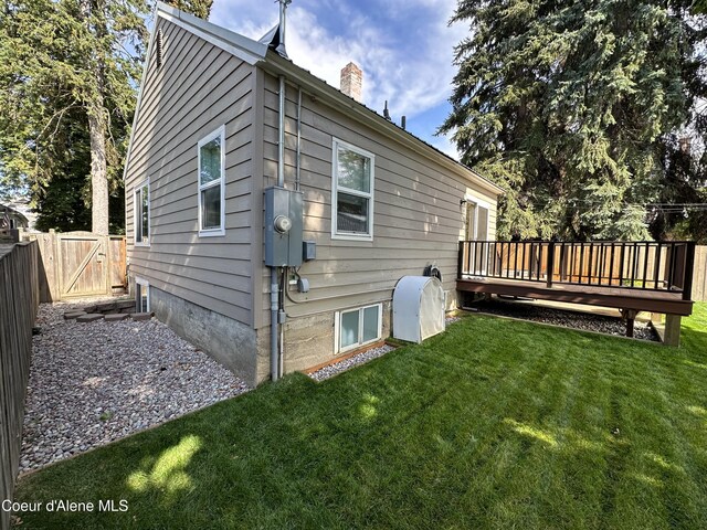 822 E Wallace Ave, Coeur Dalene, ID 83814 - rear view of property featuring fence, a chimney, a yard, and a deck