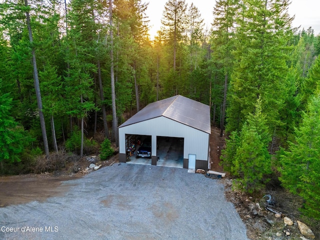 detached garage featuring a wooded view