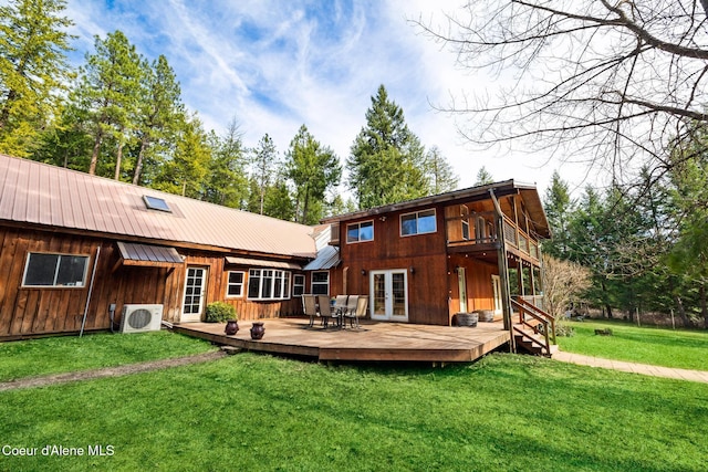 rear view of property with a deck, french doors, metal roof, ac unit, and a yard