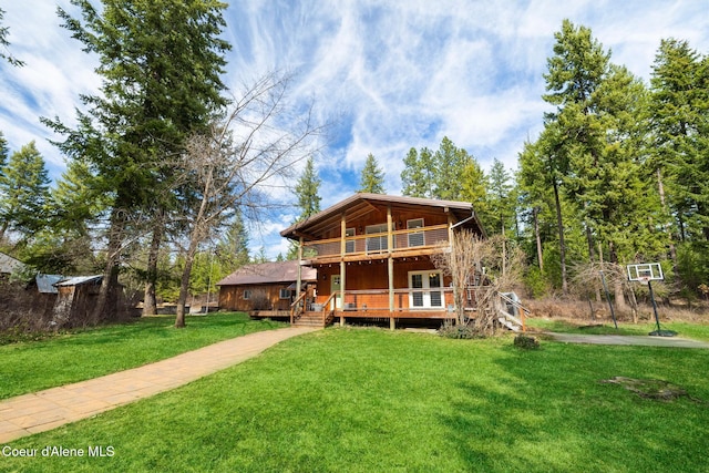 13168 N Clauson Trl, Rathdrum, ID 83858 - rear view of house with a lawn, a wooden deck, and french doors