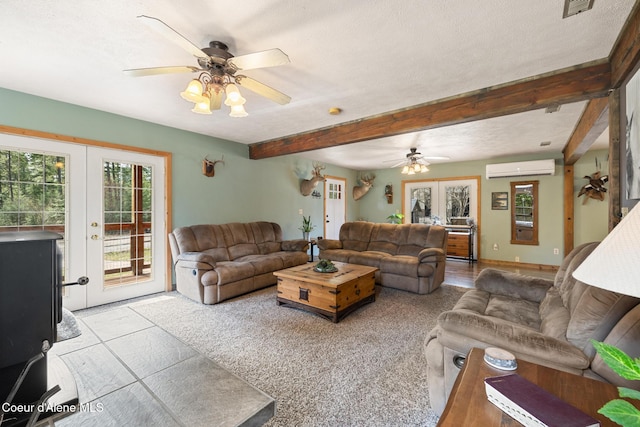 living area featuring visible vents, beamed ceiling, a wall mounted AC, french doors, and a ceiling fan