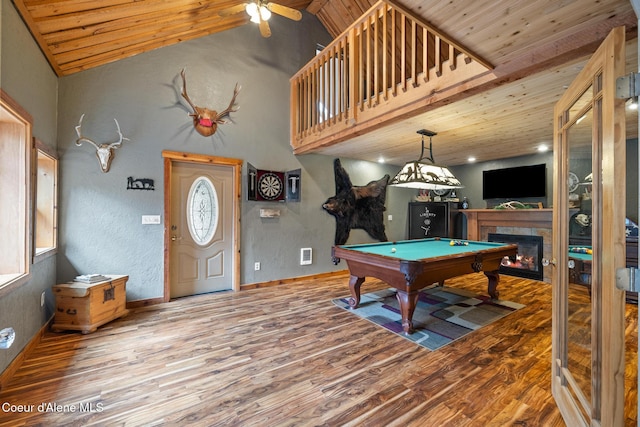 recreation room with wood ceiling, a ceiling fan, pool table, wood finished floors, and a tile fireplace