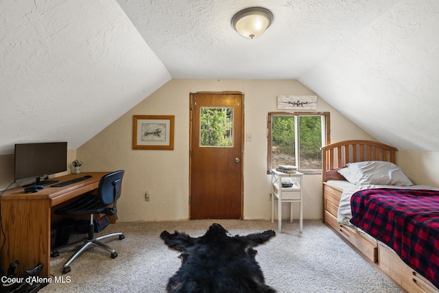 bedroom with carpet flooring, a textured ceiling, and lofted ceiling