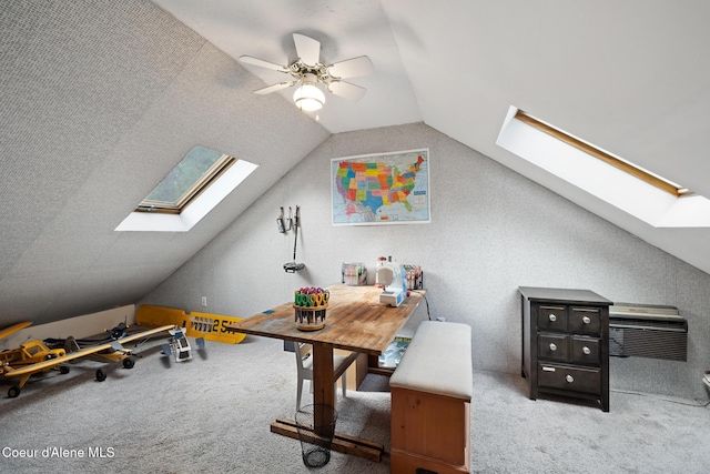 office with ceiling fan, carpet, and vaulted ceiling with skylight