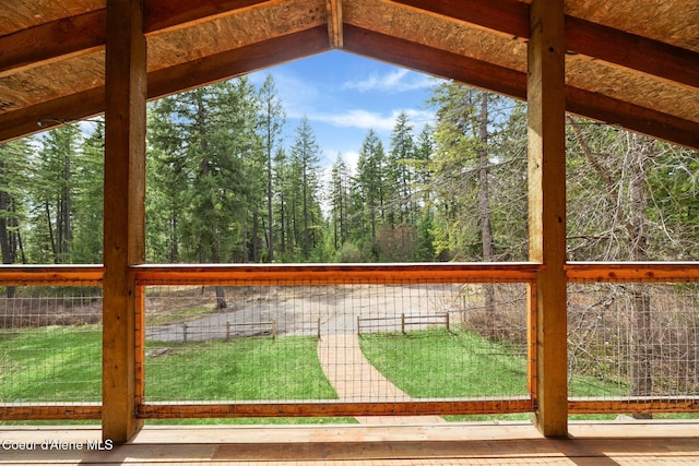 exterior space featuring a yard and a wooded view