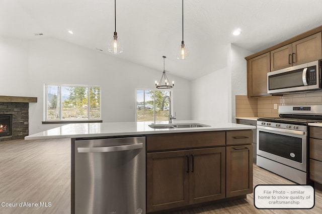 LT7BLK1 E Valley St, Oldtown, ID 83822 - kitchen with decorative backsplash, open floor plan, a sink, light wood finished floors, and appliances with stainless steel finishes