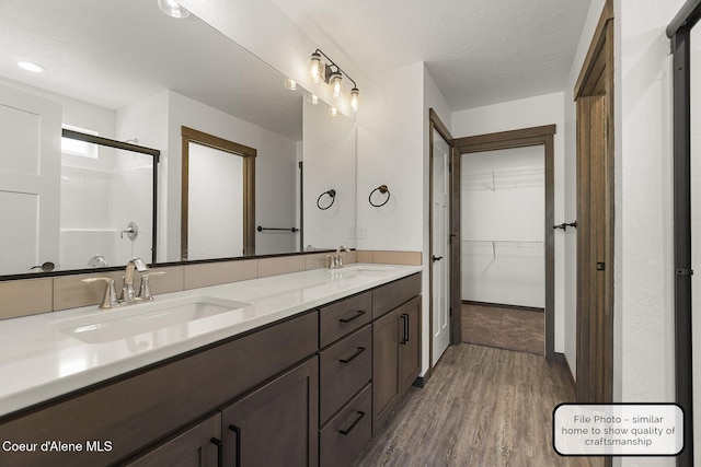 LT7BLK1 E Valley St, Oldtown, ID 83822 - bathroom with a sink, a shower stall, wood finished floors, and a spacious closet