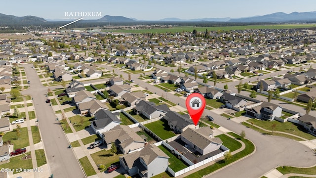 drone / aerial view with a residential view and a mountain view