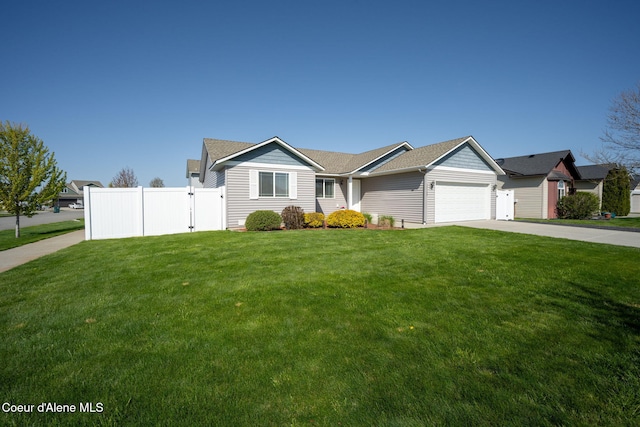 ranch-style home with an attached garage, fence, driveway, and a front yard