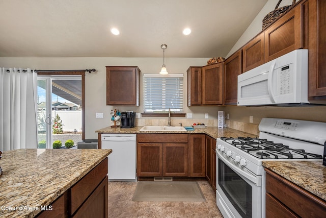 kitchen featuring a sink, vaulted ceiling, white appliances, and light stone countertops