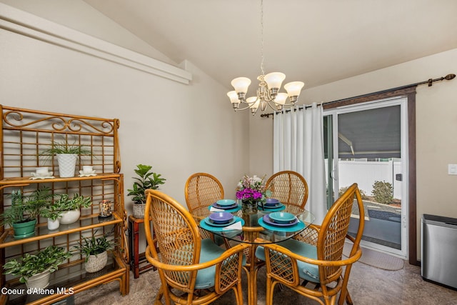 dining area with carpet floors, a chandelier, and vaulted ceiling