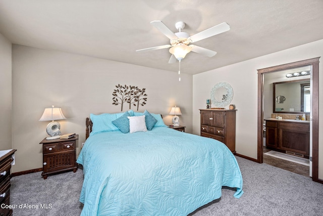 bedroom featuring baseboards, carpet flooring, ceiling fan, and ensuite bath