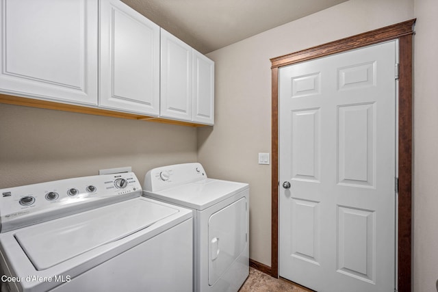 clothes washing area featuring cabinet space, independent washer and dryer, and baseboards