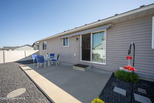 back of house with fence and a patio area