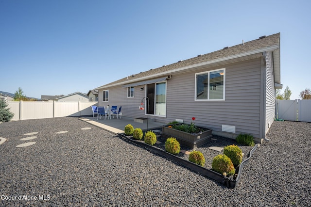 back of property featuring a patio and a fenced backyard