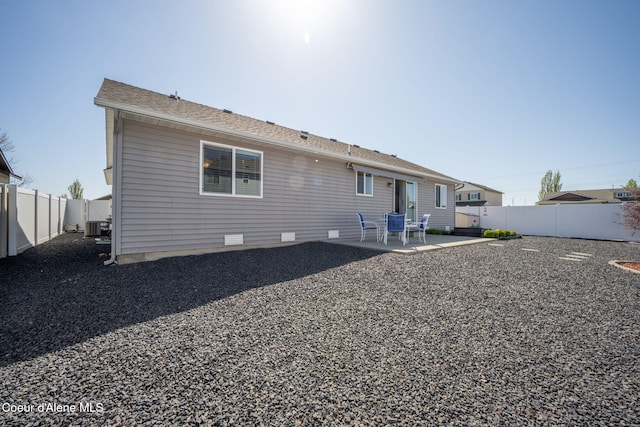 back of property with a patio, a fenced backyard, central air condition unit, and crawl space